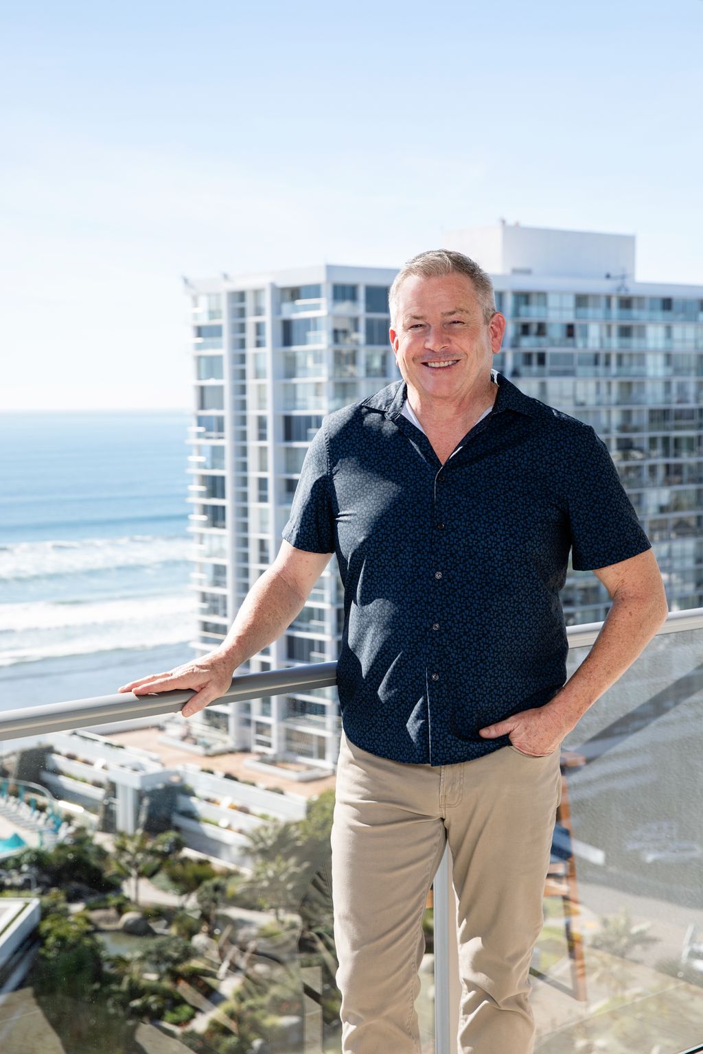 Tom Tilford standing on a Coronado Shores balcony overlooking the ocean